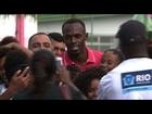 Usain Bolt tours Rio favela sports area