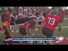 High school football players pay tribute to cancer-stricken cheerleader