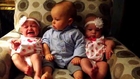 Confused baby between twins